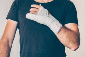 Man with a work-related hand injury who may be eligible for workplace compensation