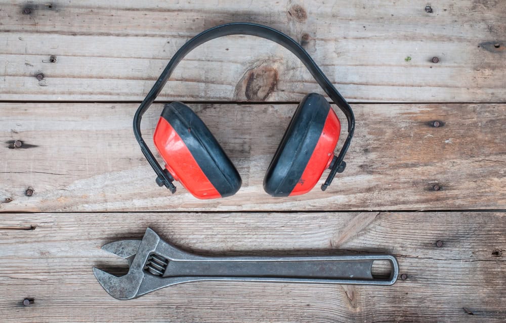 Old,Wrench,And,Earphone,Put,On,Wood,Background.
