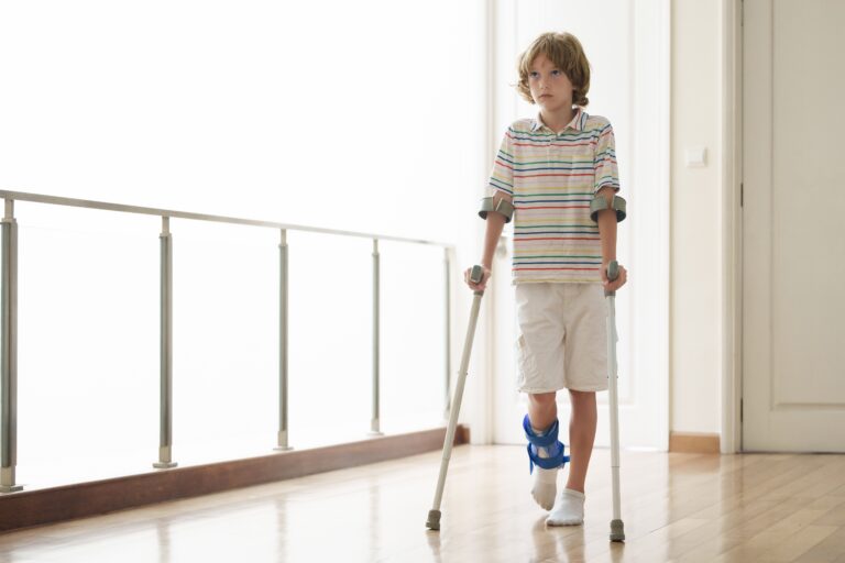Injured,Child,On,Crutches.,Boy,In,Cast,On,Foot,And