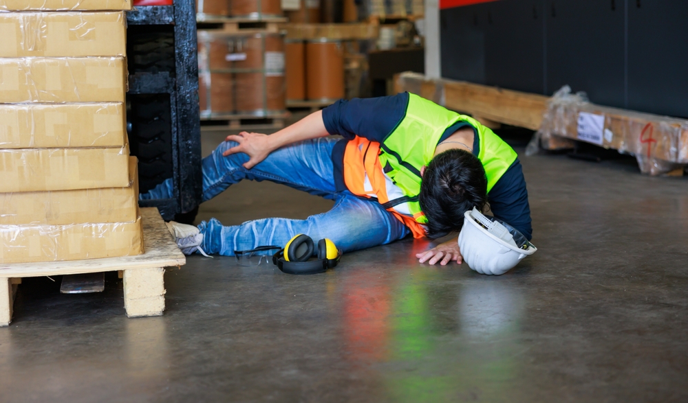 first aid safety concept warehouse man