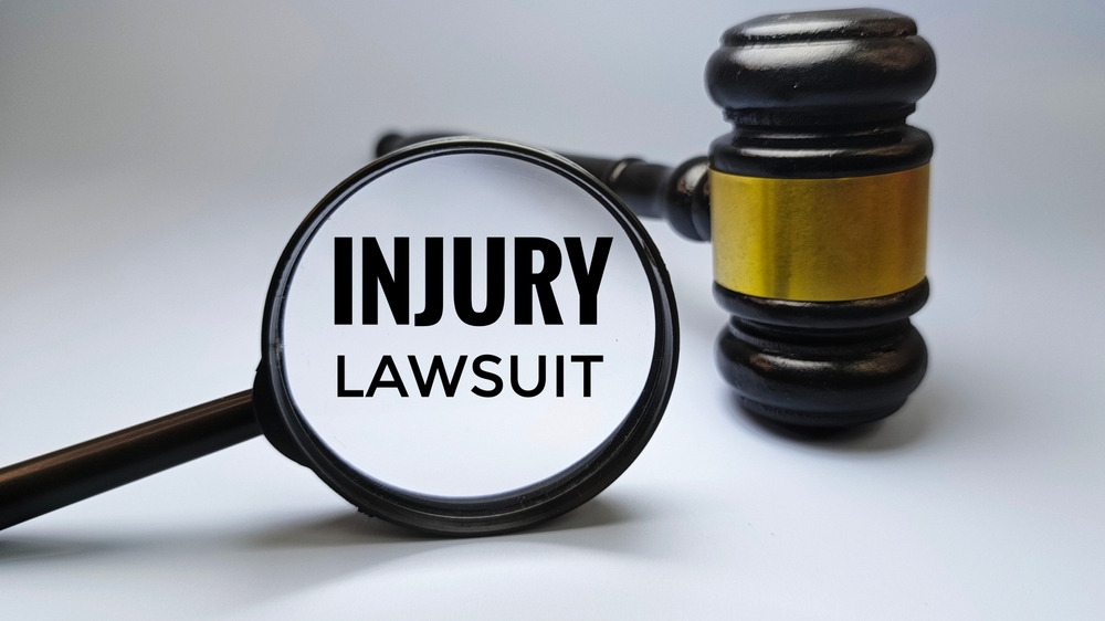 injury lawsuit concept shown magnifying glass